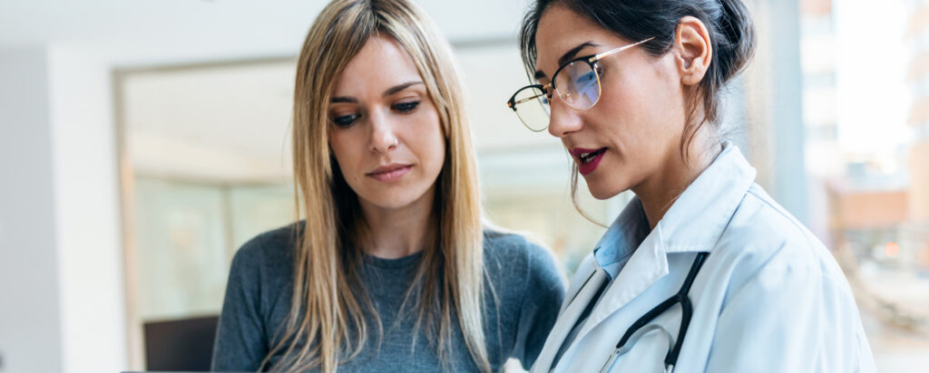 Doctor with patient looking at a tablet